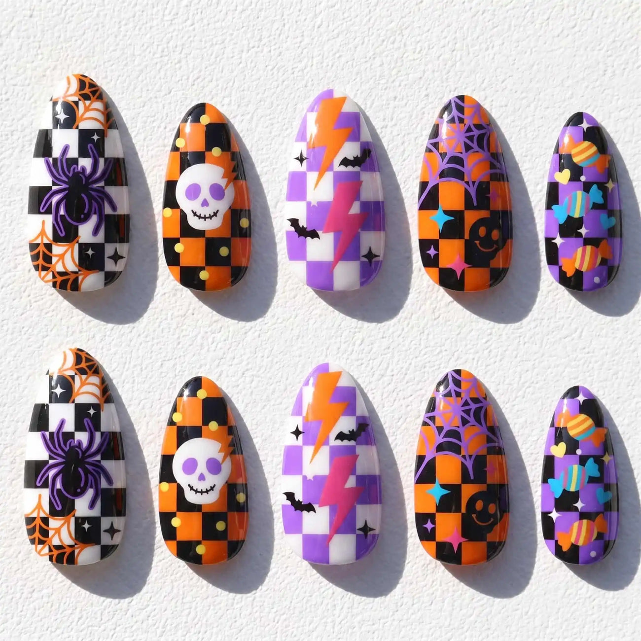 orange and purple patchwork with skulls and spider webs halloween almond press on nails — spooky season design