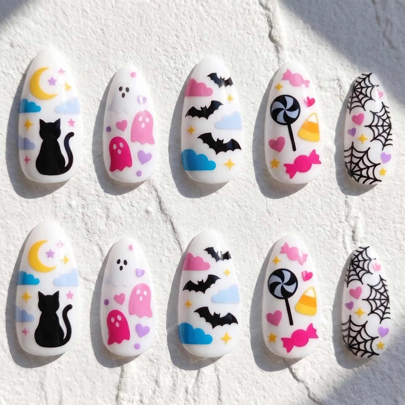 pastel ghosts, candy, and black cat halloween almond press on nails — spooky season design