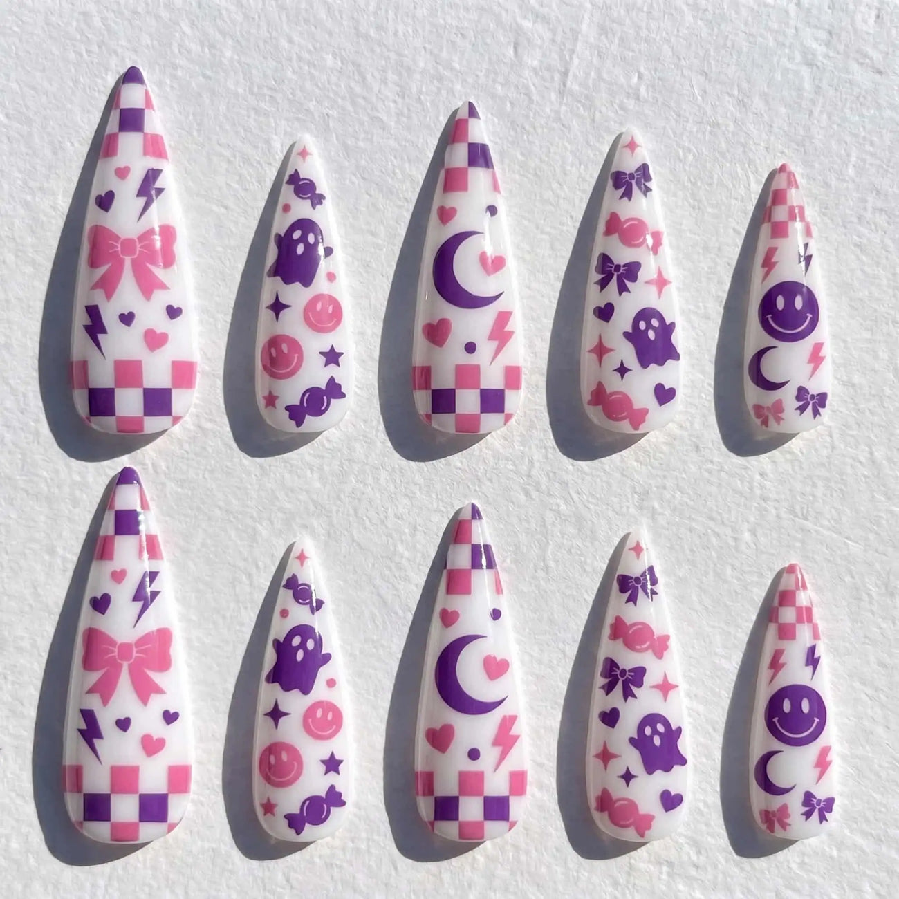 pink checkerboard, ghost, and moon halloween stiletto press on nails — spooky season design
