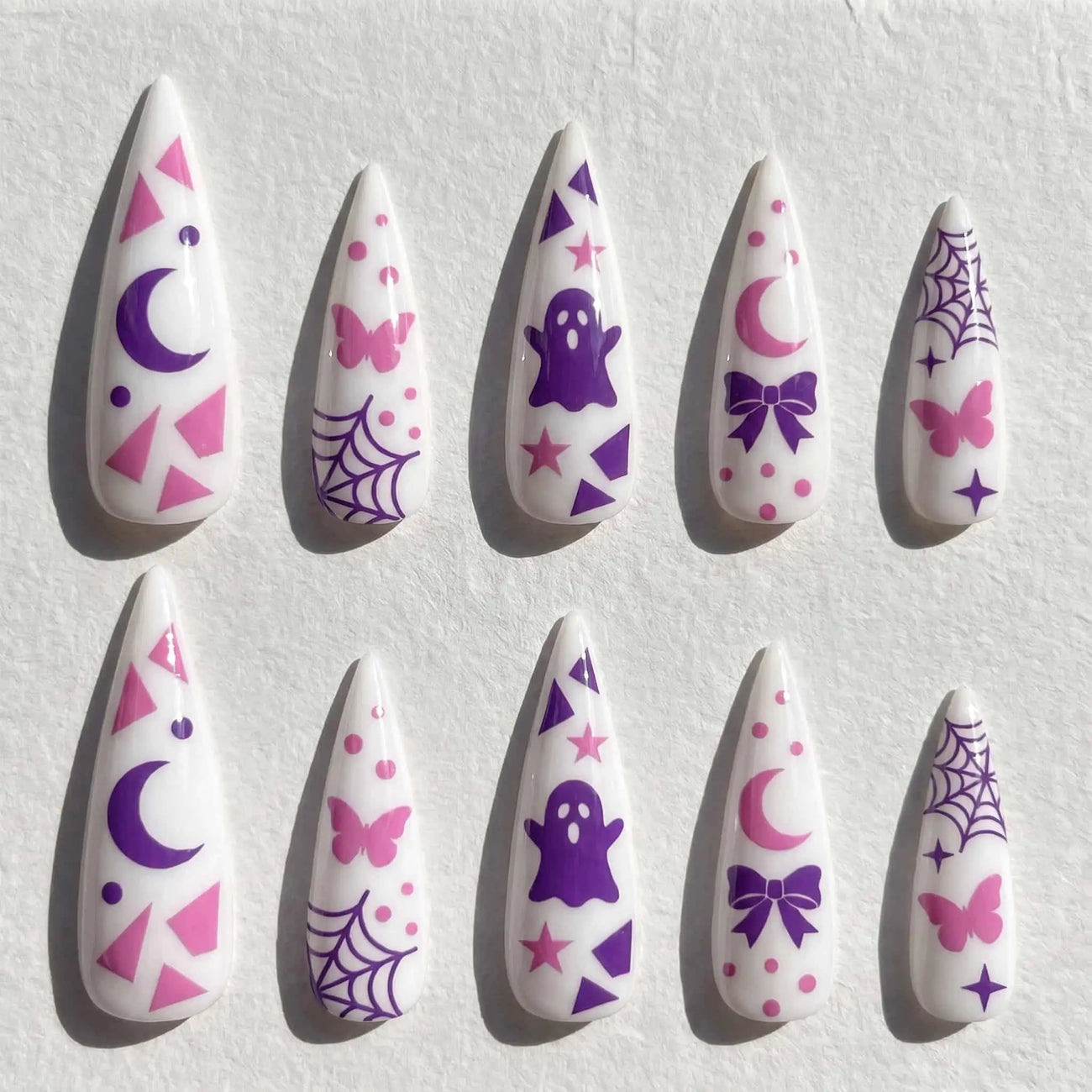 pink moons, bows, bats, and spider webs halloween stiletto press on nails — spooky season design