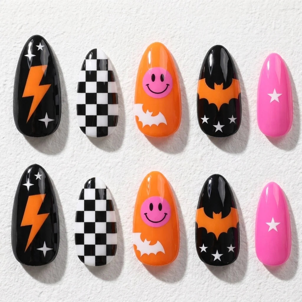 Bat Bolt short almond press-on nails — bats, lightning, checkerboard, and a smiling orange accent