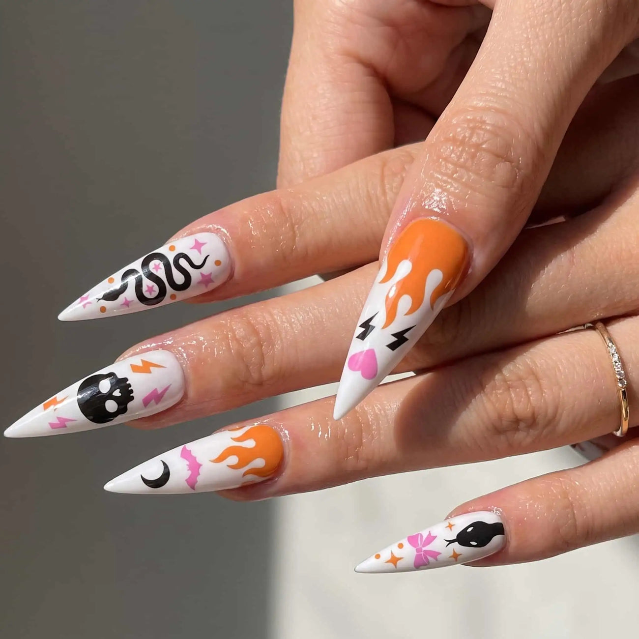 halloween stiletto press on nails worn look, orange flames, snakes, and skulls