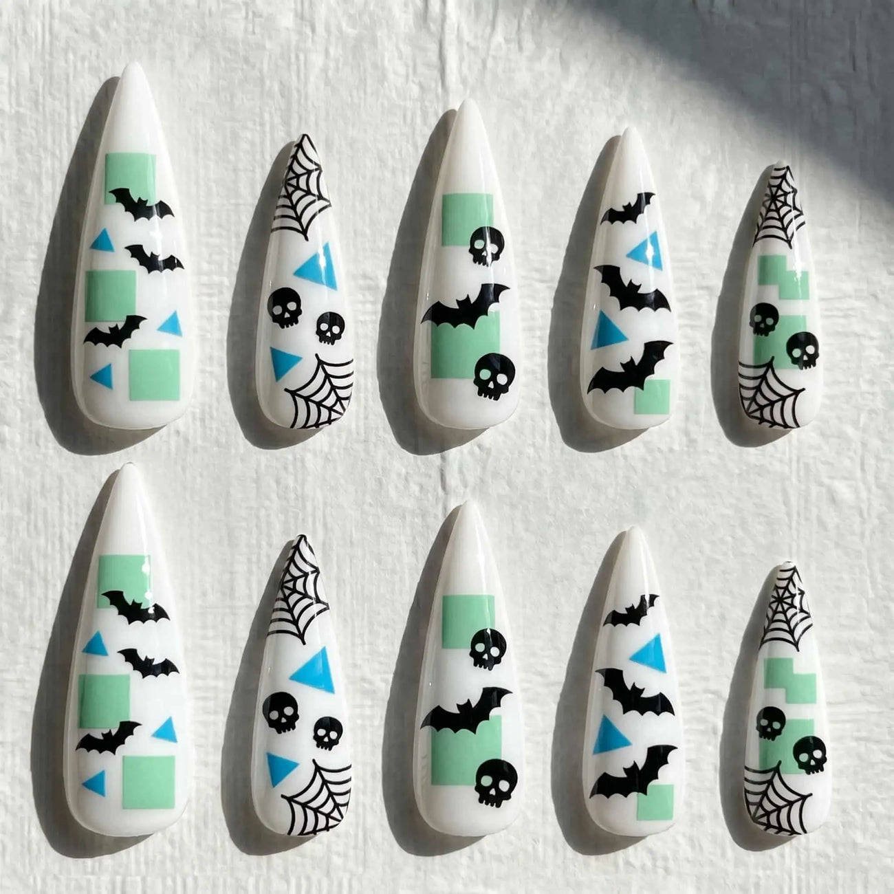 mint bats, skulls, and spider webs halloween stiletto press on nails — spooky season design