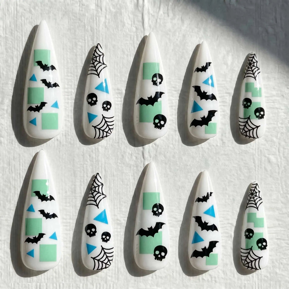 mint bats, skulls, and spider webs halloween stiletto press on nails — spooky season design