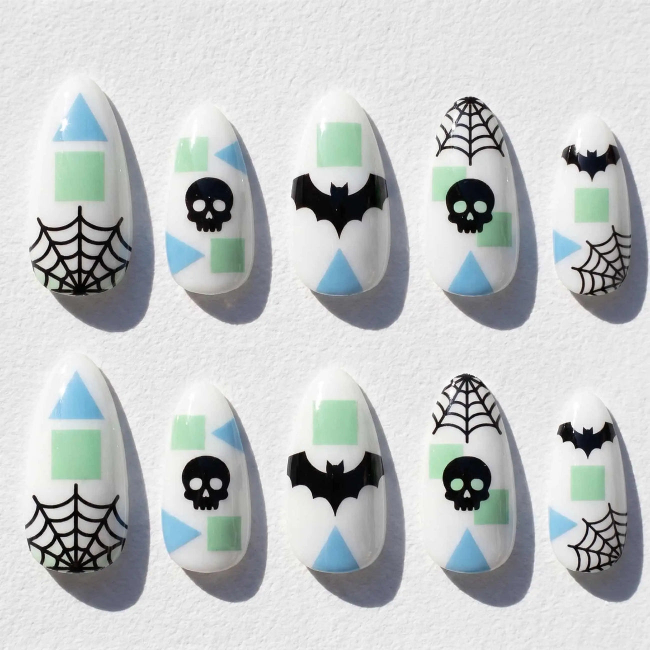 mint geometric skull and bat halloween almond press on nails — spooky season design