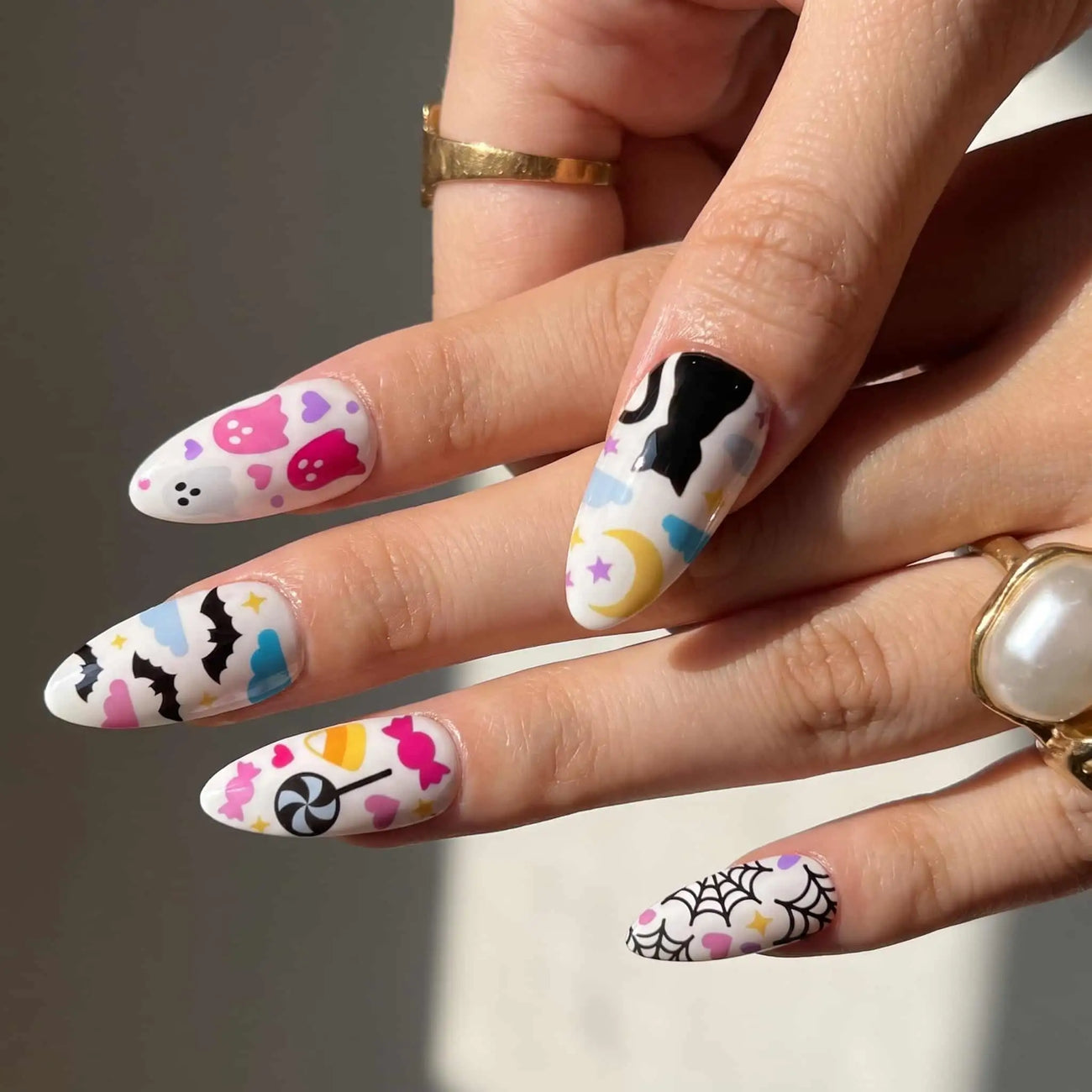 halloween almond press on nails worn look, pastel ghosts, candy, and black cat