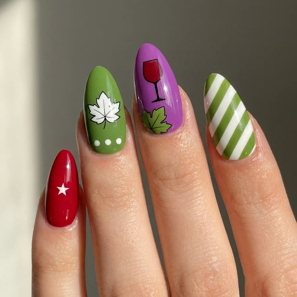 Vineyard Mix short almond press-on nails worn on hand — grape, wine glass, maple leaf, and striped art